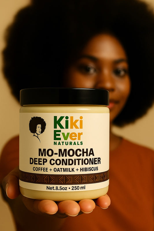 Person holding a jar of Kiki Ever Naturals Mo-Mocha Deep Conditioner with a blurred background